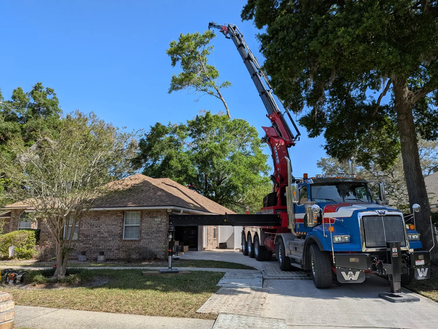 Jax Tree Removal crane truck and crew on a Jacksonville tree removal job