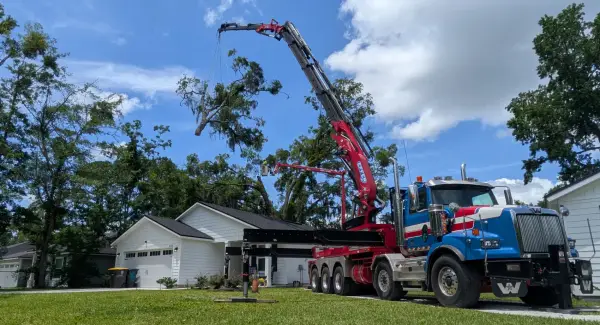 Expert tree removal crane over home orange park — crane tree removal in Jacksonville, FL by Jax Tree Removal